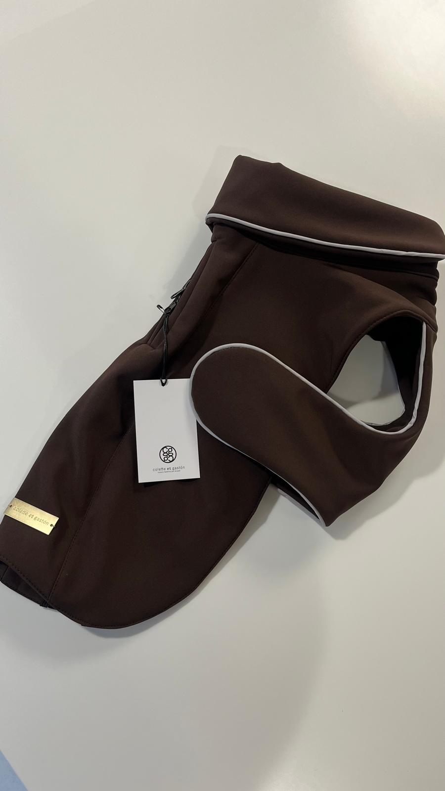 Brown pet coat with a brand tag on a light gray background